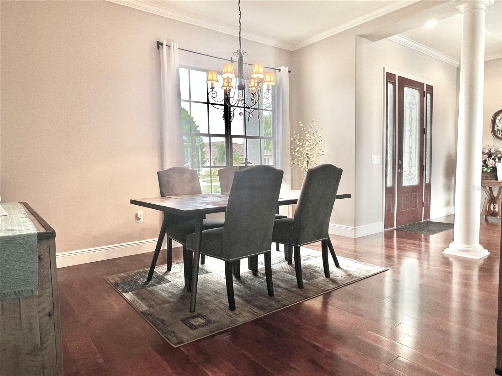 The dining room is spacious, features crown molding, 5-1/4" baseboards, and filled with natural light.