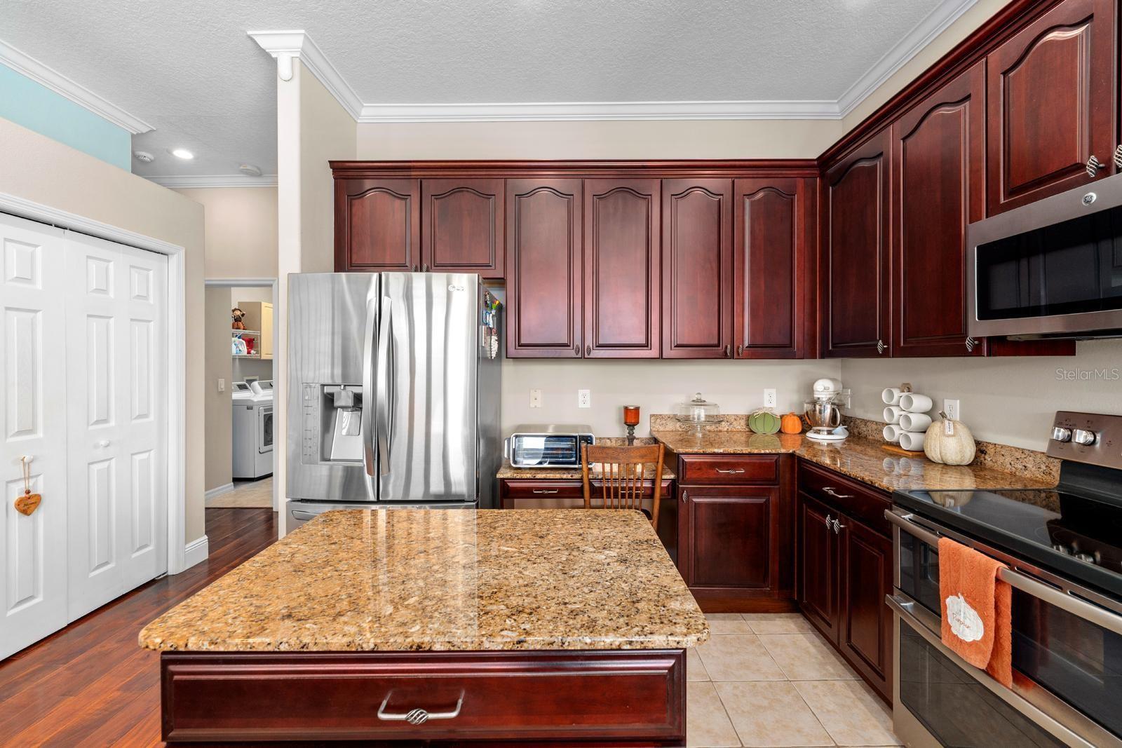 The beautiful Chef's Kitchen features TWO large pantries, 42" cabinets with crown molding, granite counters, a storage island, stainless appliances, a double oven, and recessed lighting!