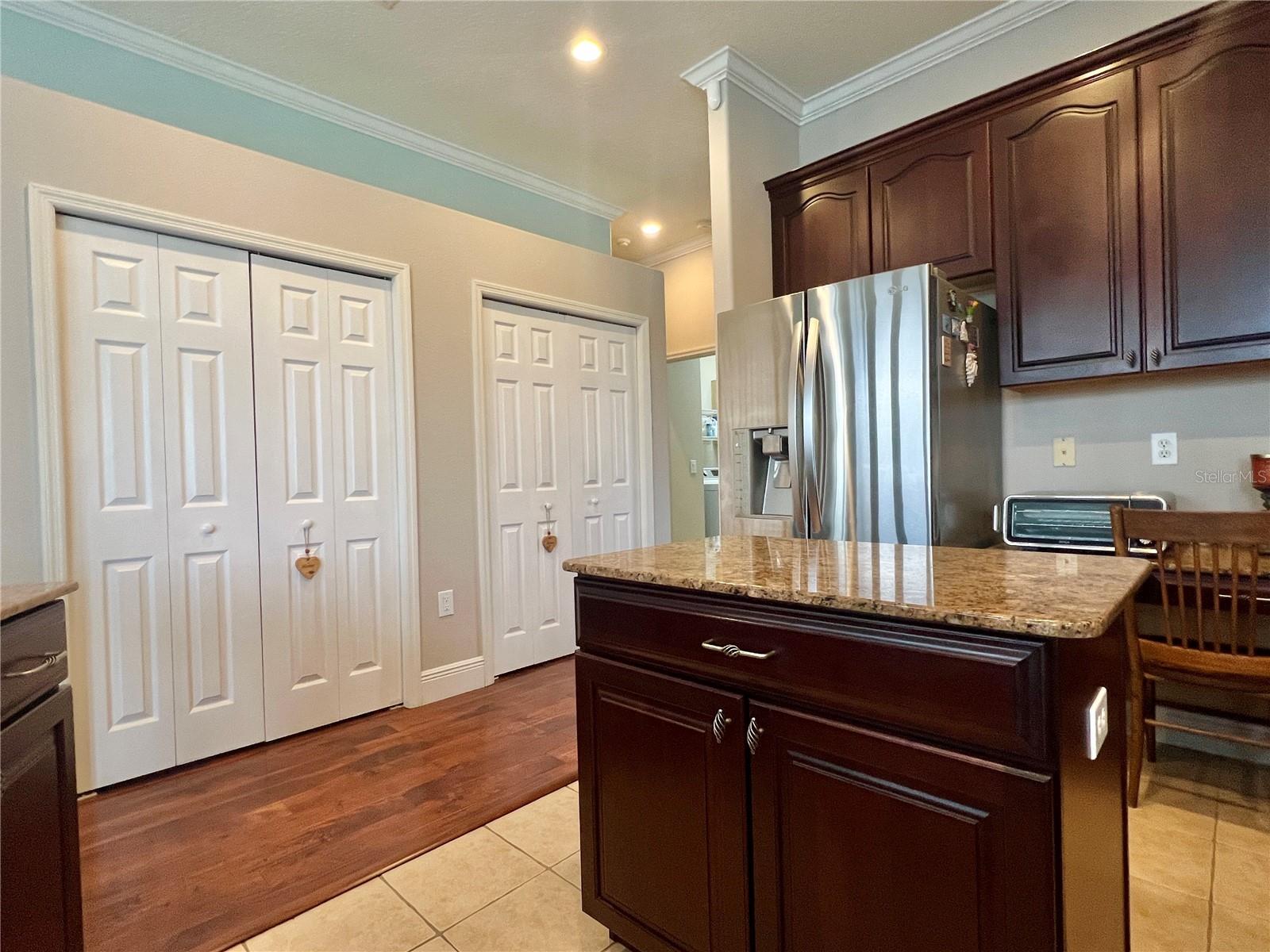 The beautiful Chef's Kitchen features TWO large pantries, 42" cabinets with crown molding, granite counters, a storage island, stainless appliances, a double oven, and recessed lighting!