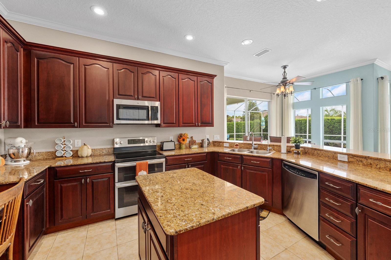 The beautiful Chef's Kitchen features TWO large pantries, 42" cabinets with crown molding, granite counters, a storage island, stainless appliances, a double oven, and recessed lighting!
