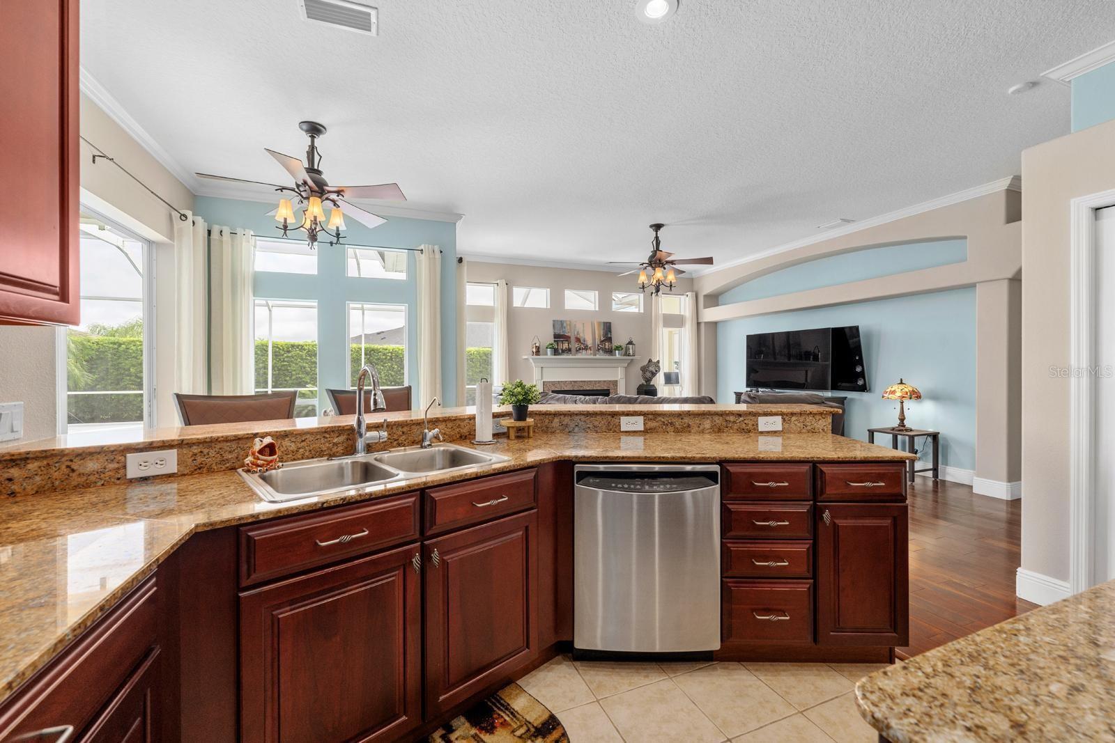 The beautiful Chef's Kitchen features TWO large pantries, 42" cabinets with crown molding, granite counters, a storage island, stainless appliances, a double oven, and recessed lighting!