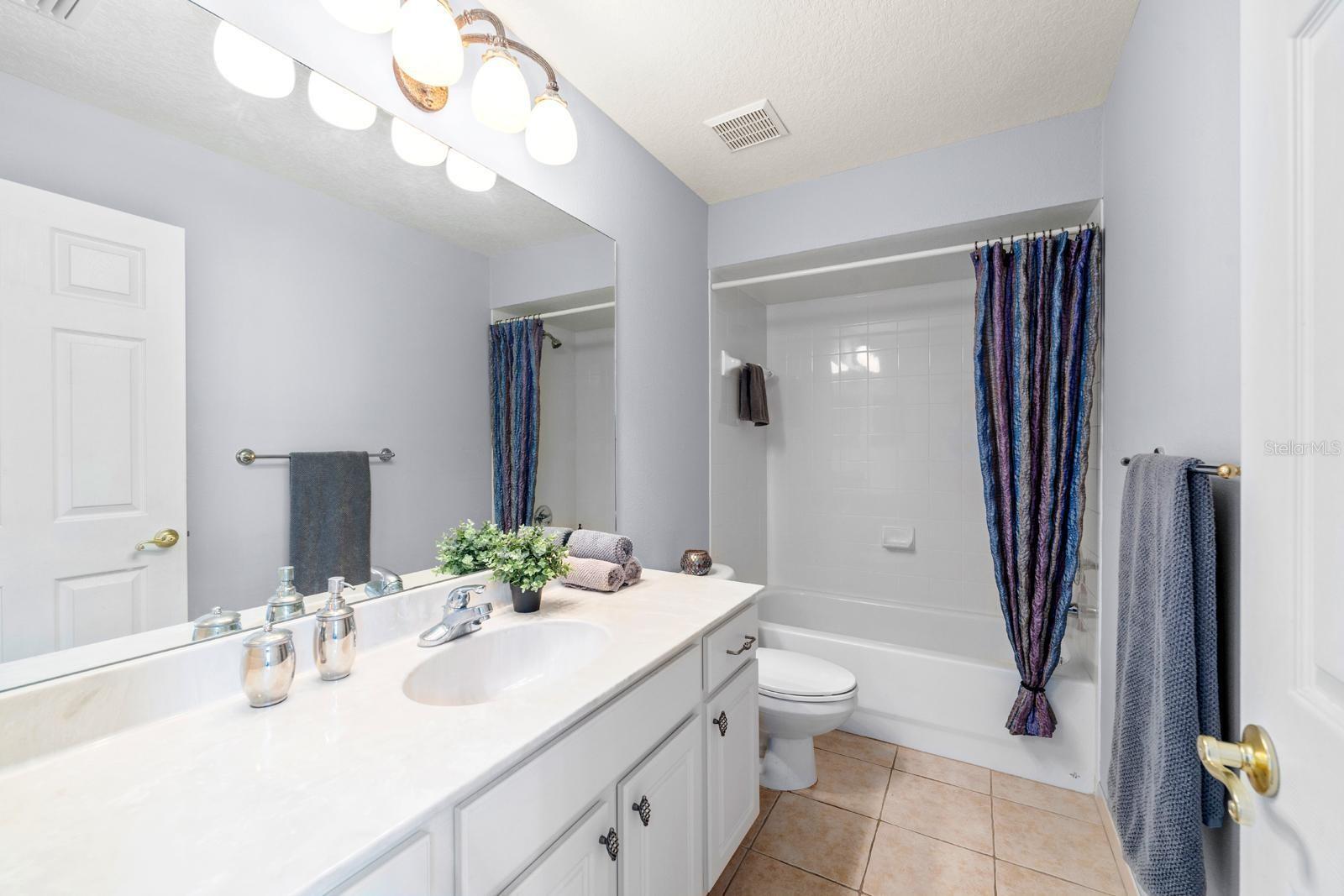 Two of the secondary bedrooms share a hall bathroom....meticulously clean and ample counter space and storage room.  Two closets are just outside the door.