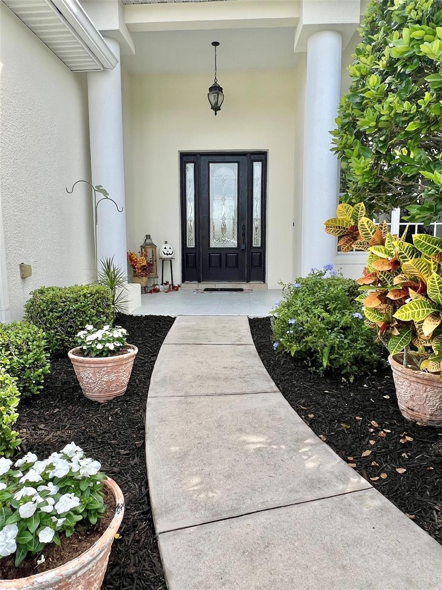 The landscaping is lush and well-maintained.   There are electrical outlets located on the exterior of the home....front and back.