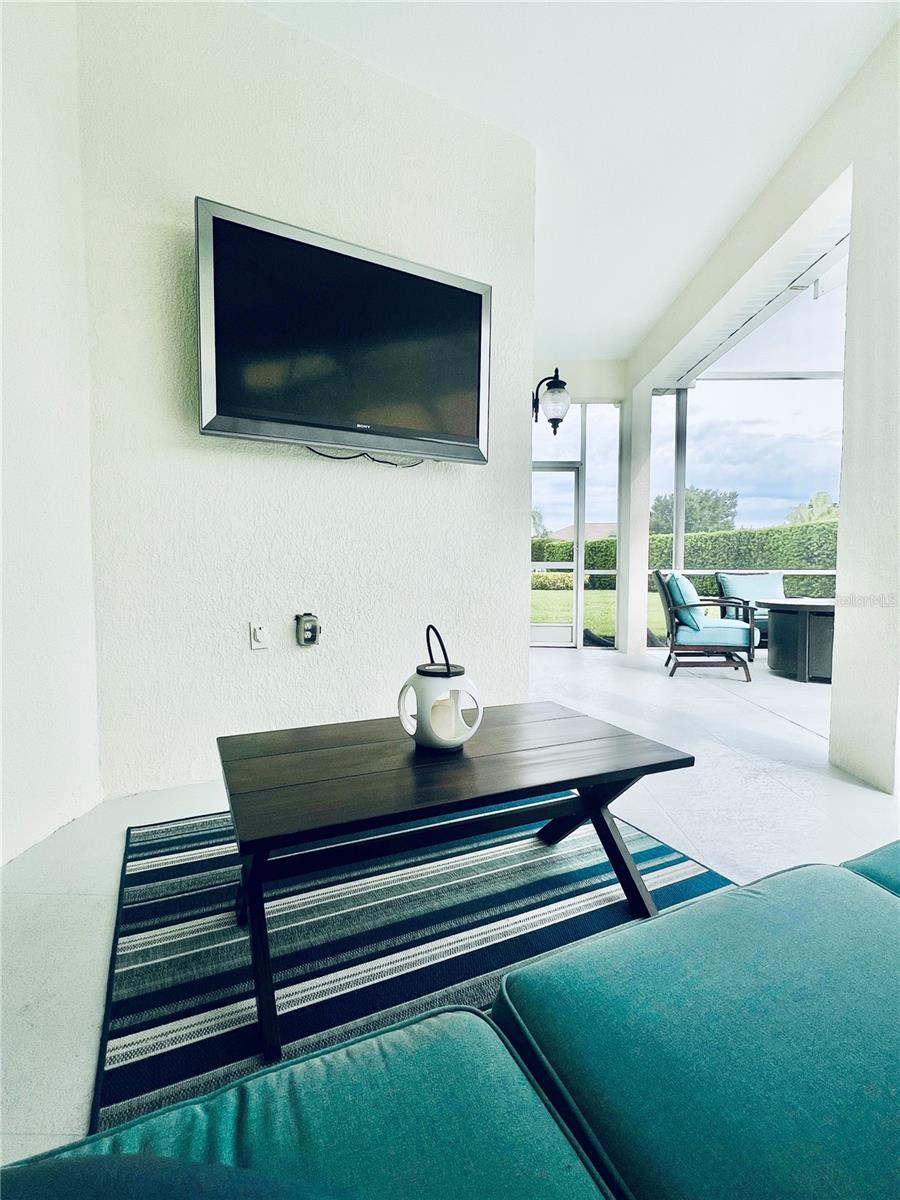 The large TV on the porch will stay with the home.  There are electrical outlets within the pool enclosure, on the front porch, and around the exterior.