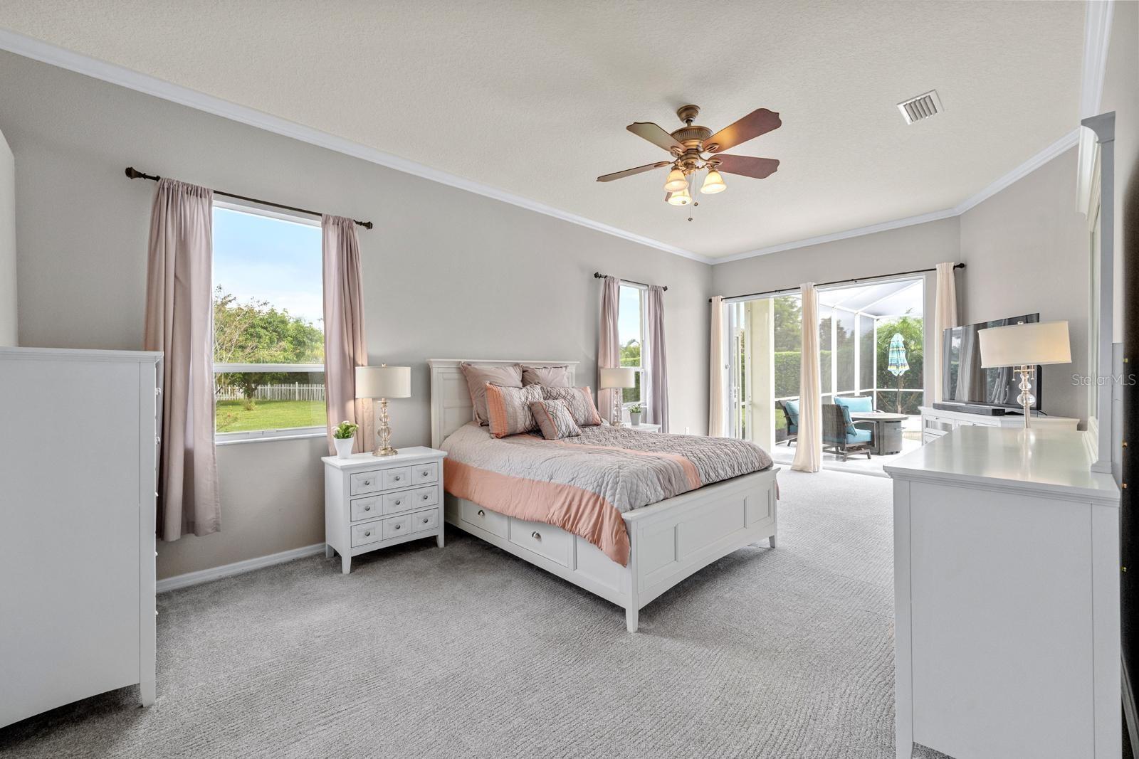 The massive primary bedroom has a slider to the back lanai and pool for those nights when you want to go out and relax.