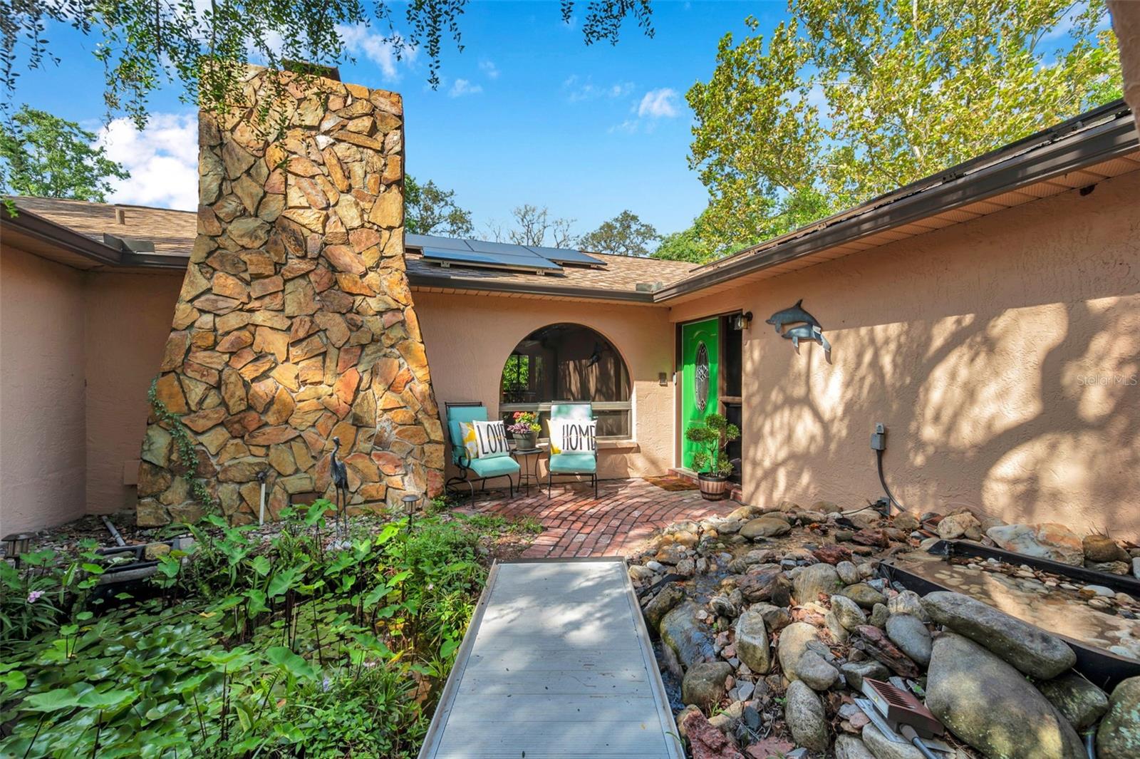 Private, Peaceful Entrance with rock stream and a pond