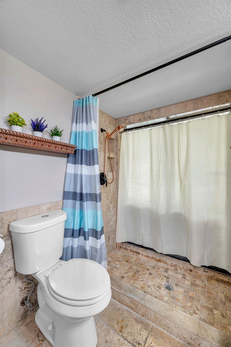 Primary bathroom with double sinks and a walk in shower