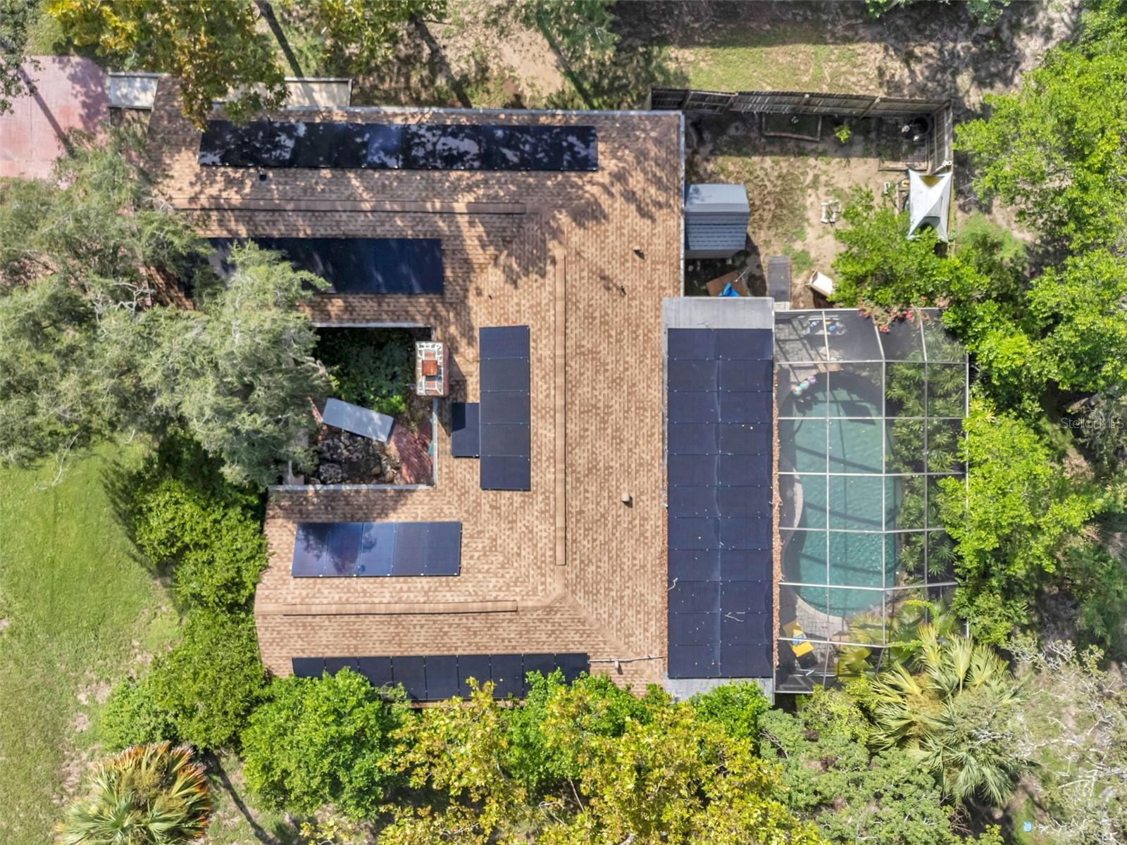 Impressive home with wide driveway, solar panels, private entrance with peaceful pond and rock stream on a corner homesite with no immediate neighbors on the side or across the street.
