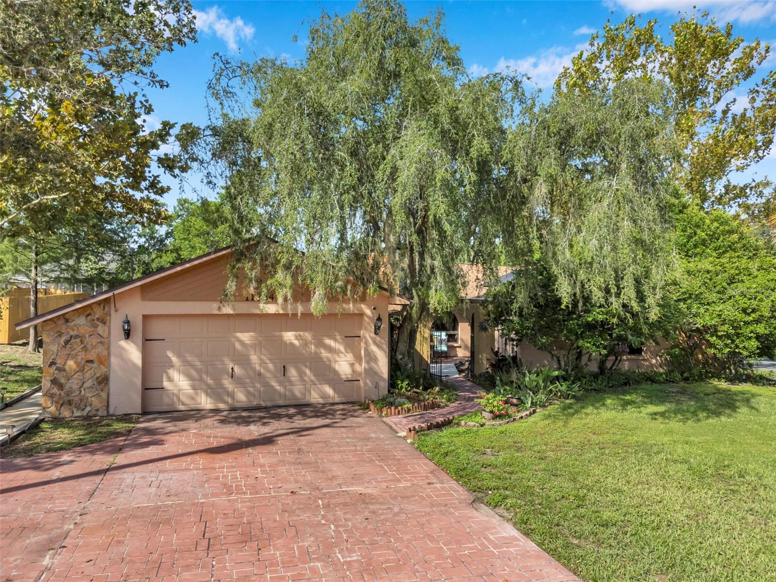 Impressive pool home with wide driveway, solar panels, private entrance with peaceful pond and rock stream on a corner homesite with no immediate neighbors across the side street.