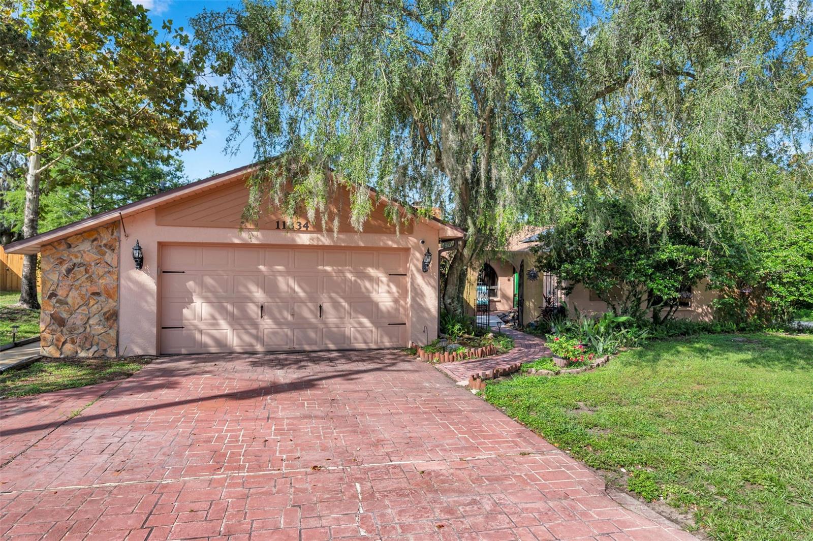 Impressive pool home with wide driveway, solar panels, private entrance with peaceful pond and rock stream on a corner homesite with no immediate neighbors across the side street.