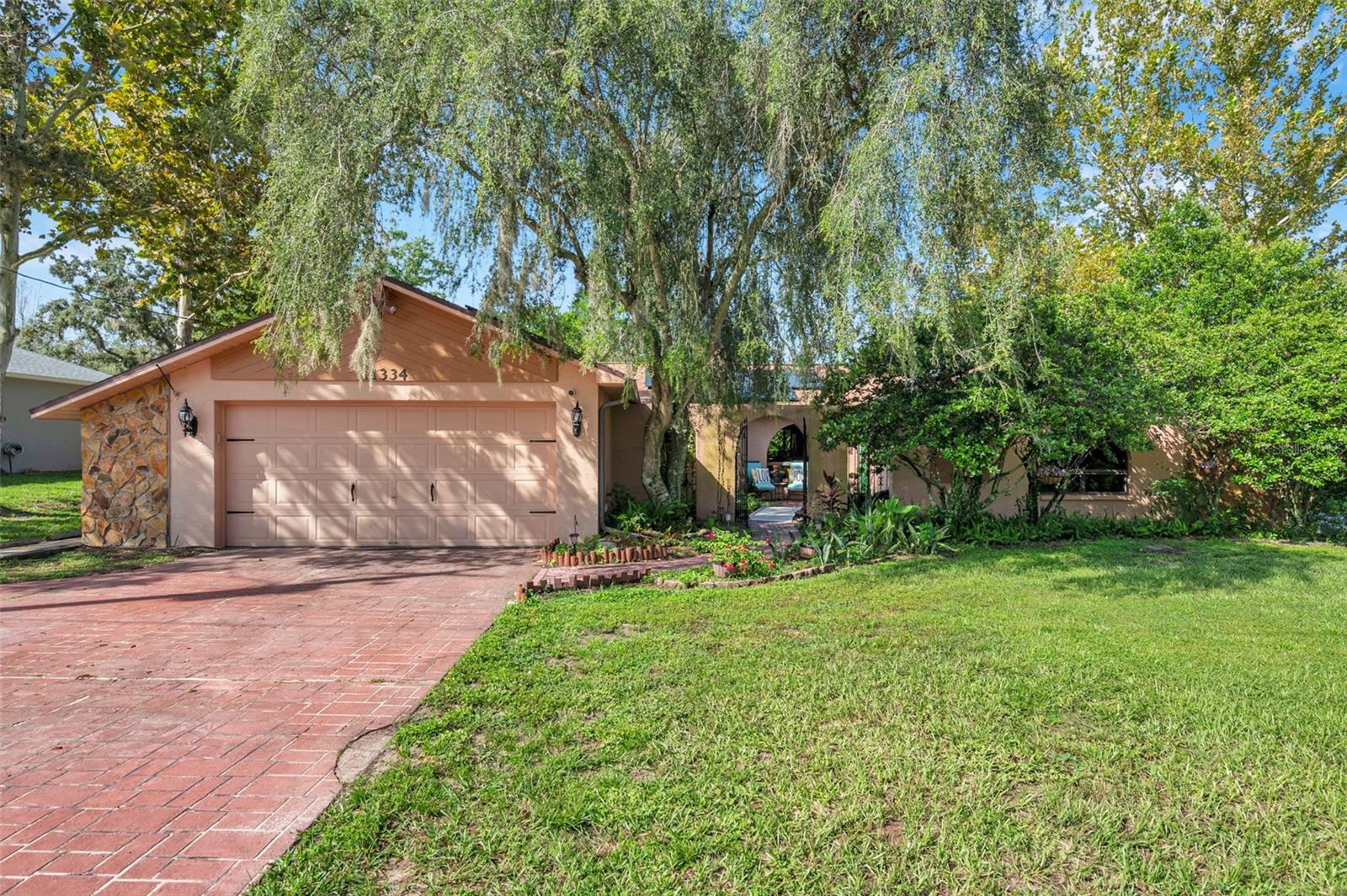 Impressive pool home with wide driveway, solar panels, private entrance with peaceful pond and rock stream on a corner homesite with no immediate neighbors across the side street.