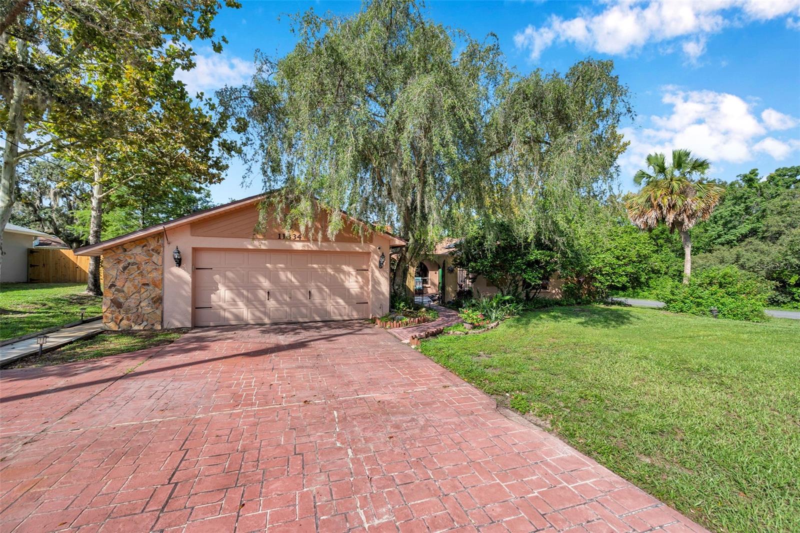 Impressive pool home with wide driveway, solar panels, private entrance with peaceful pond and rock stream on a corner homesite with no immediate neighbors across the side street.