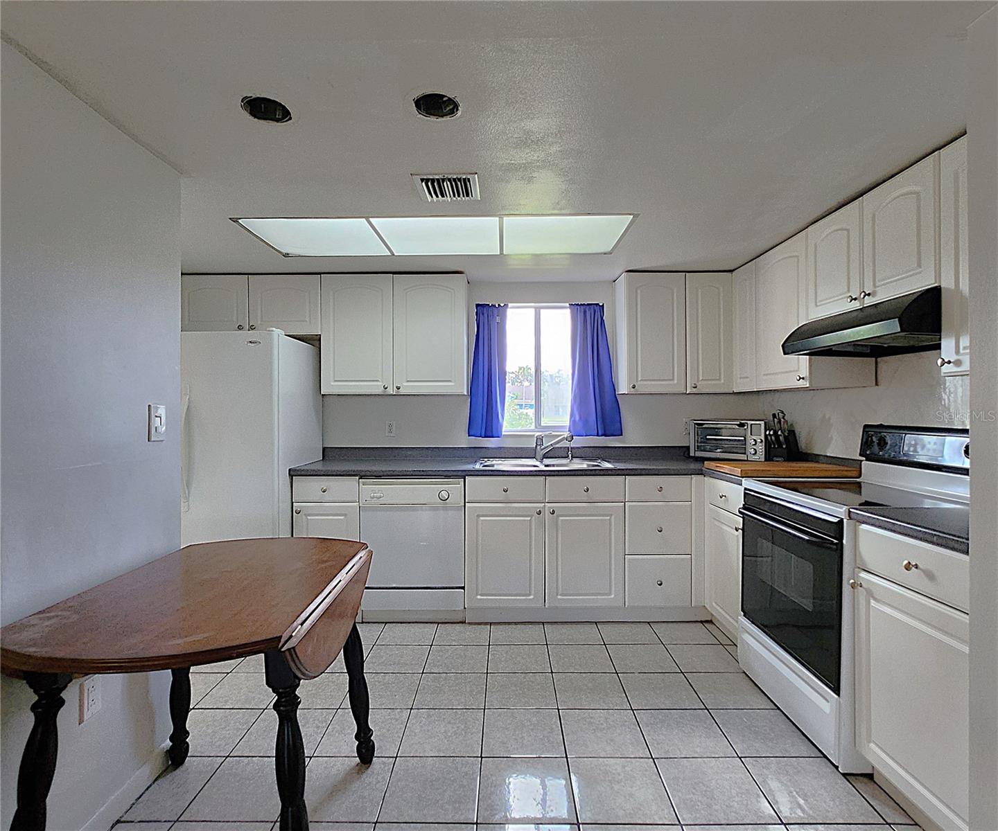 All kitchen appliances included: hooded vent, electric stove, dishwasher, refrigerator