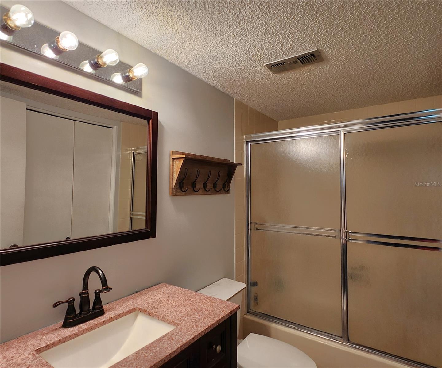 Gues Bathroom includes a Tub and Shower. Also houses the Laundry Closet w/Washer & Dryer set