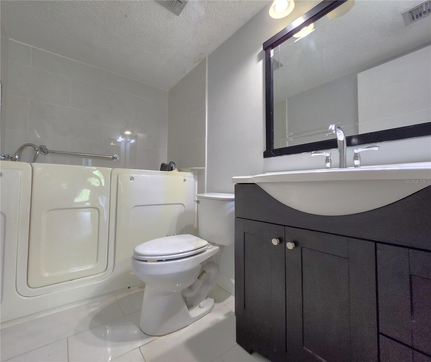 Master Bathroom includes Walk-In Whirlpool Bathtub w/Jets & built-in Seat