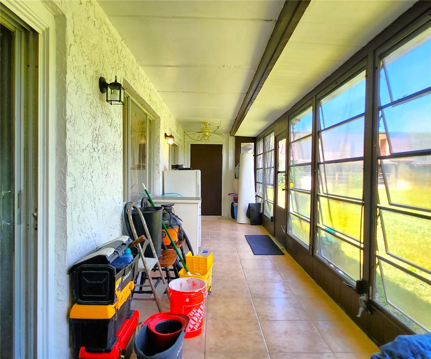 Florida Room is the same width as the Condo - wall to wall. It includes 2 ample Storage Closets, Jalousie Windows, access to the community backyard