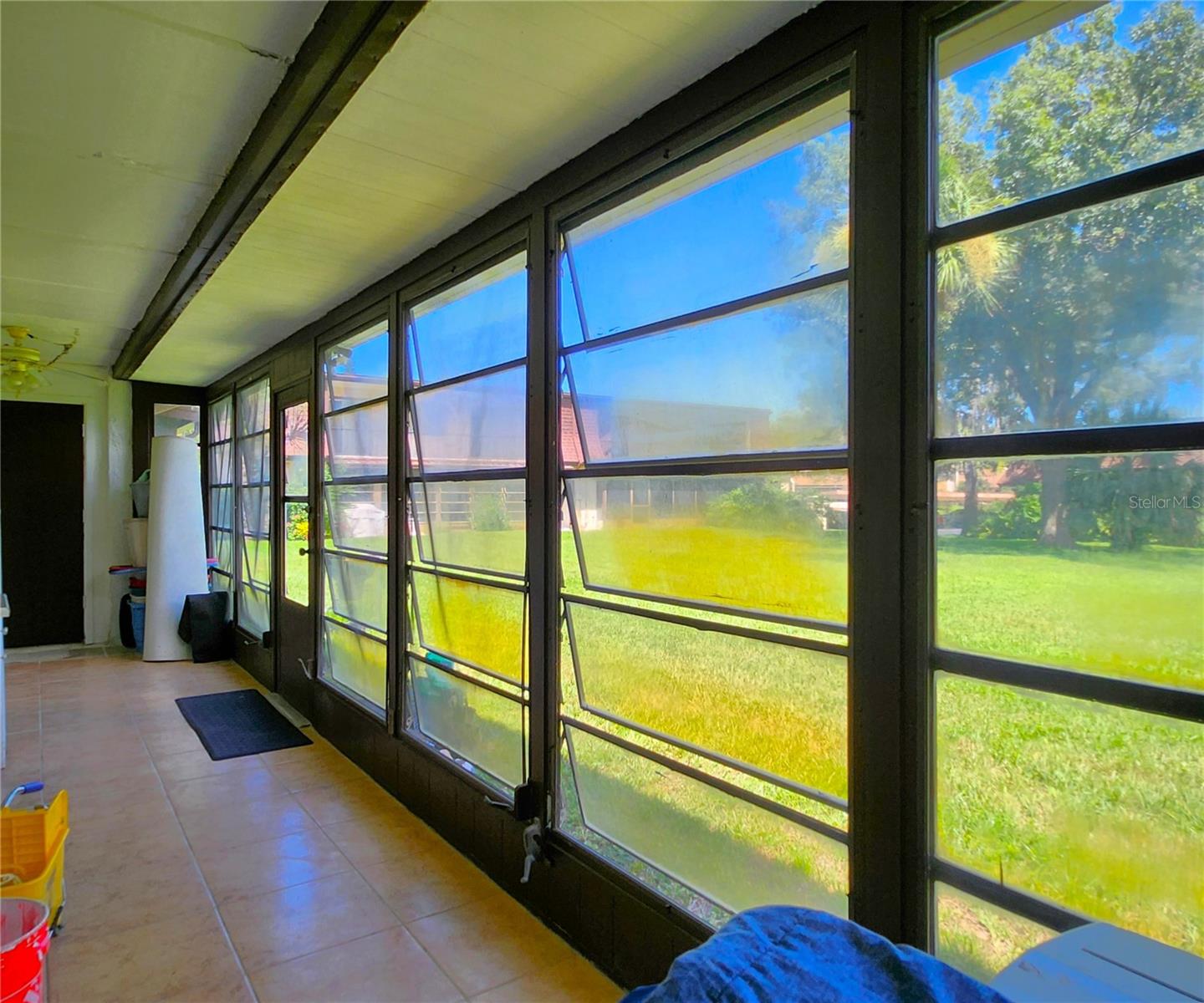 Florida Room is the same width as the Condo - wall to wall. It includes 2 ample Storage Closets, Jalousie Windows, access to the community backyard