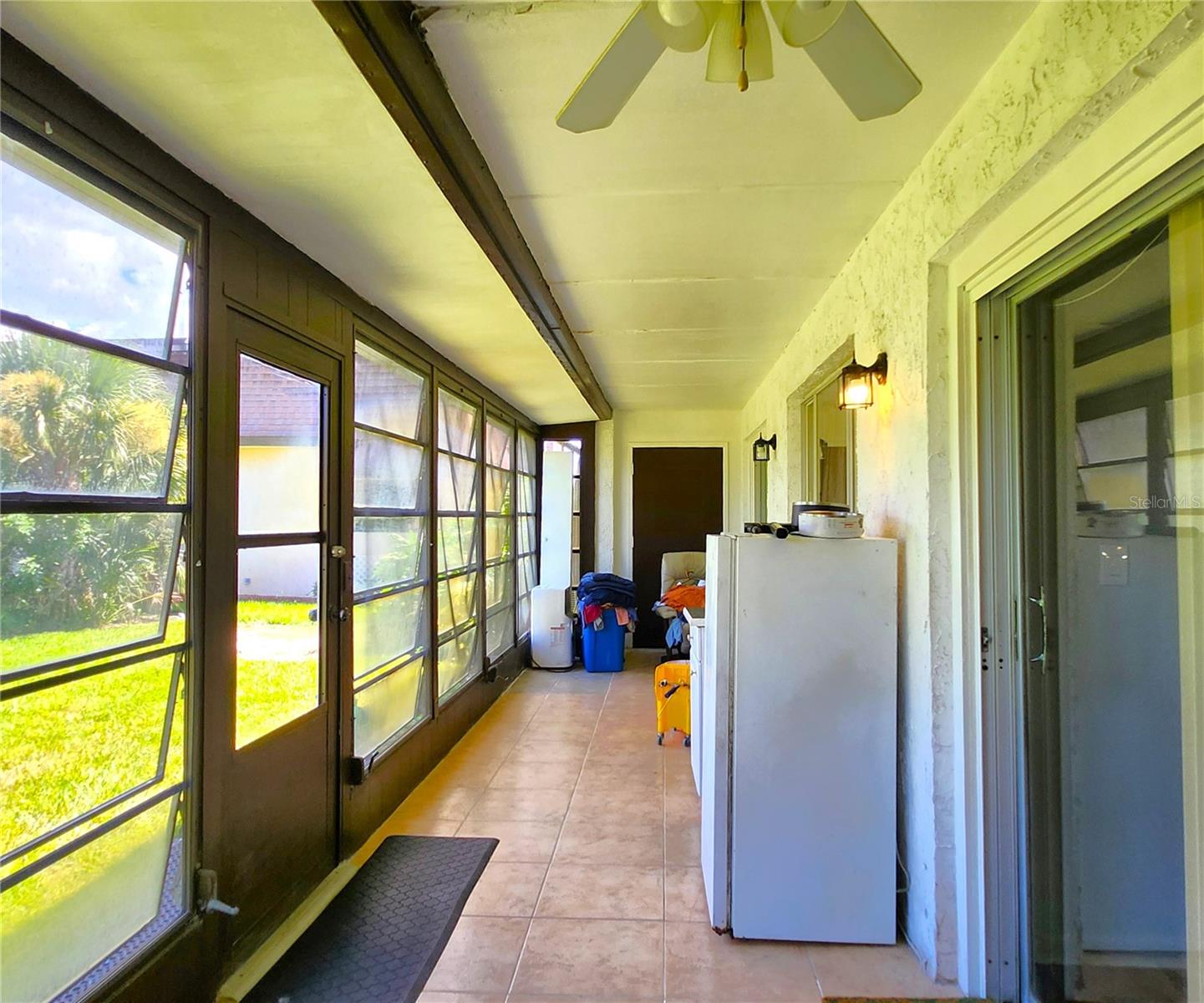 Florida Room is the same width as the Condo - wall to wall. It includes 2 ample Storage Closets, Jalousie Windows, access to the community backyard