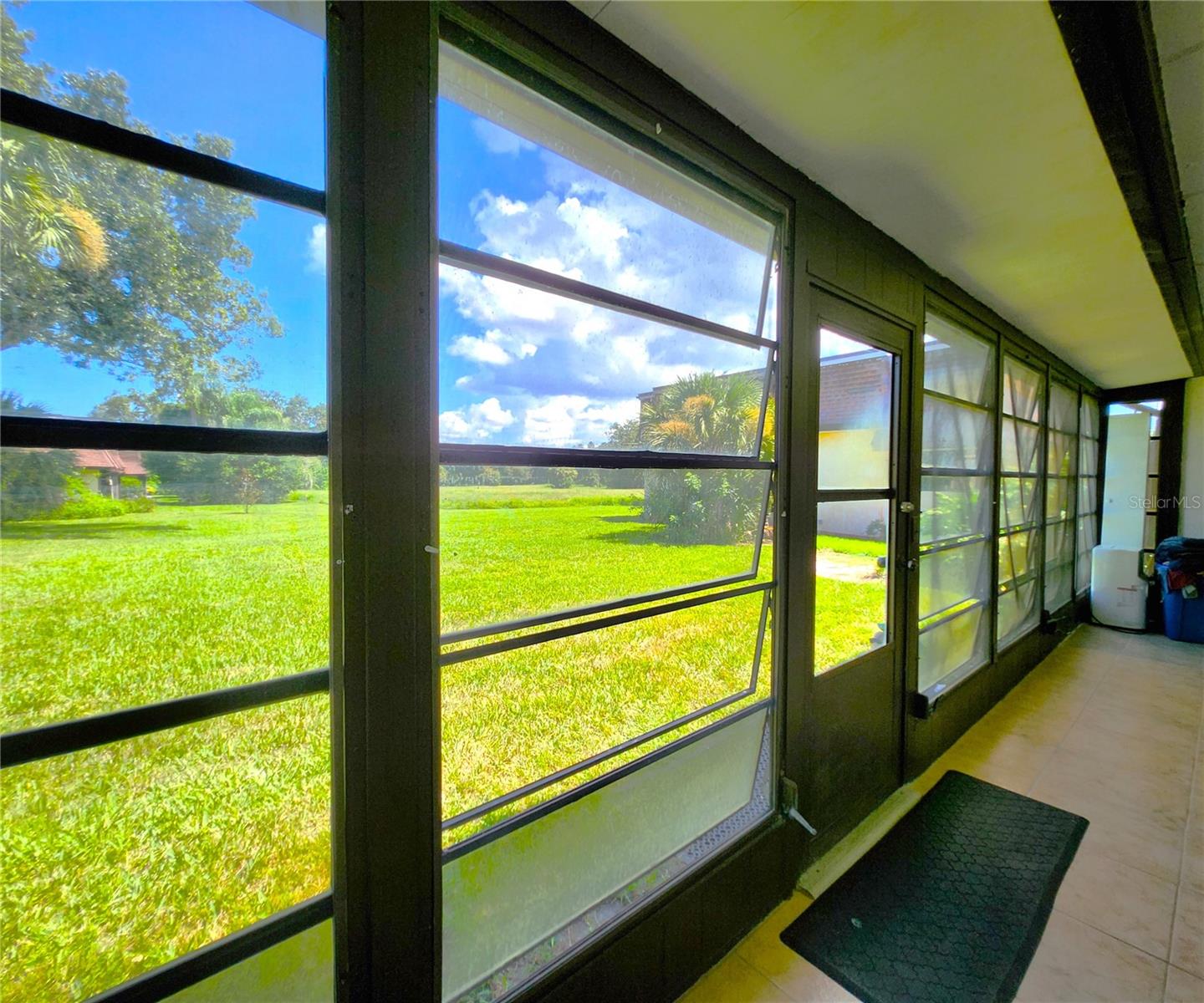 Florida Room is the same width as the Condo - wall to wall. It includes 2 ample Storage Closets, Jalousie Windows, access to the community backyard