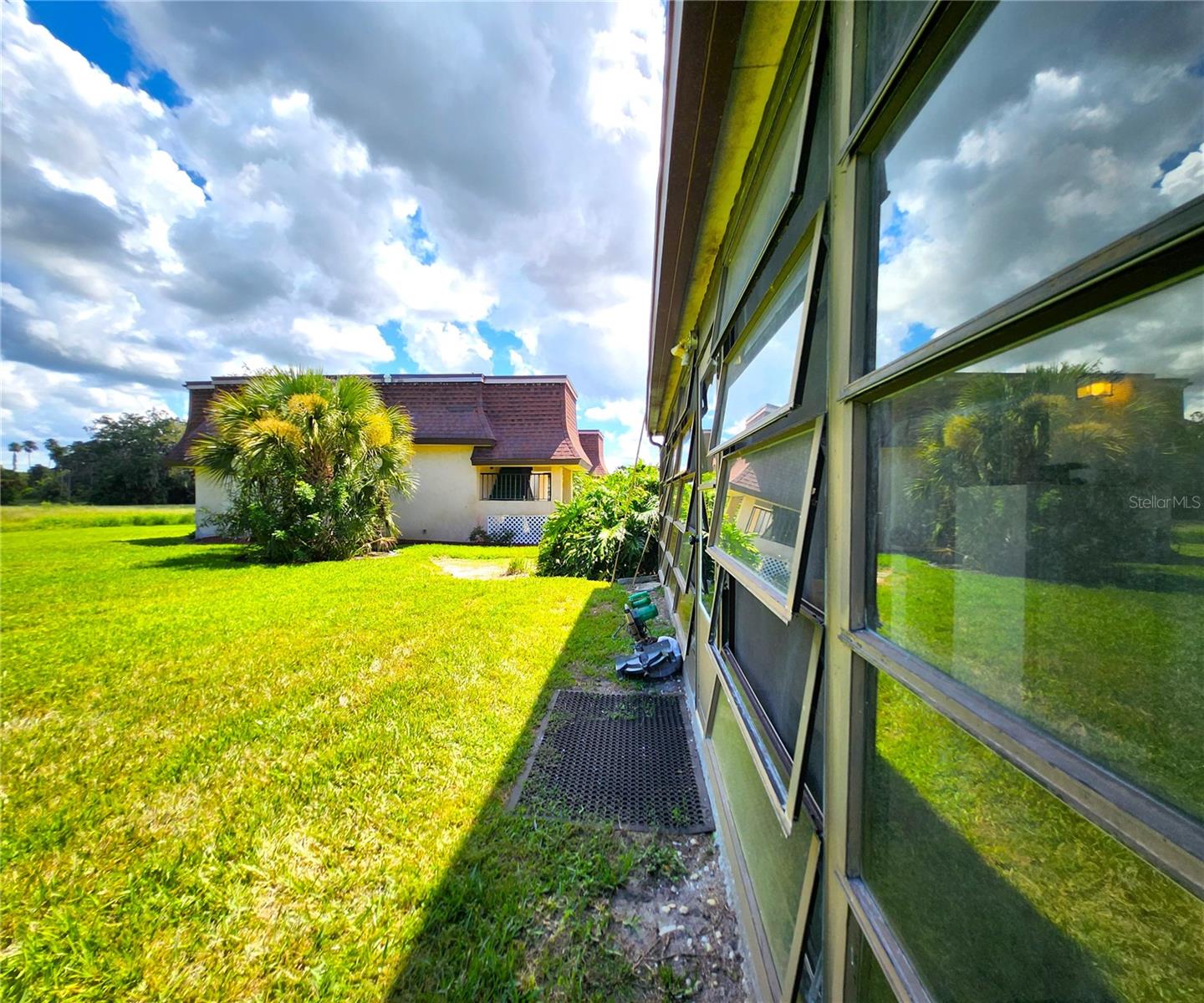 Florida Room is the same width as the Condo - wall to wall. It includes 2 ample Storage Closets, Jalousie Windows, access to the community backyard