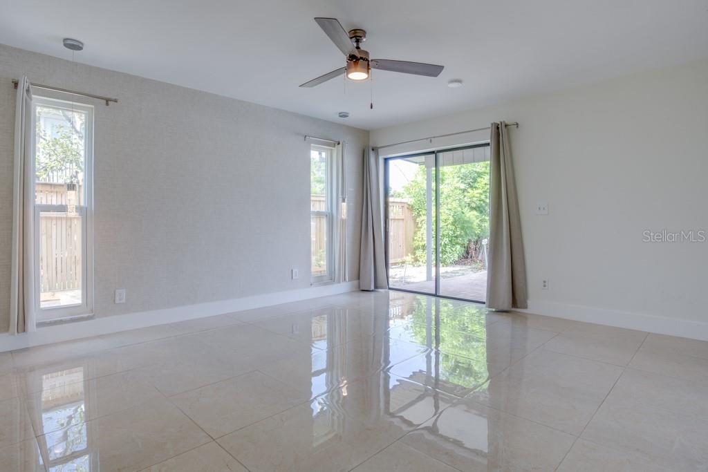 Primary suite offers water views and sliders leading to the pool