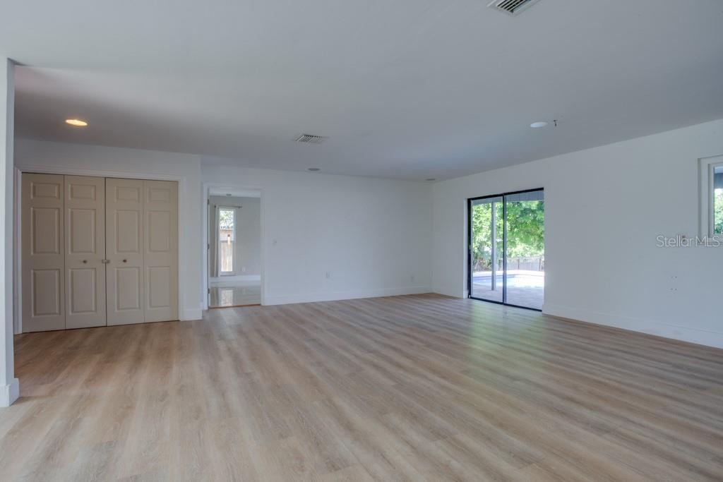 Living room offer two sets of sliders leading to the pool.
