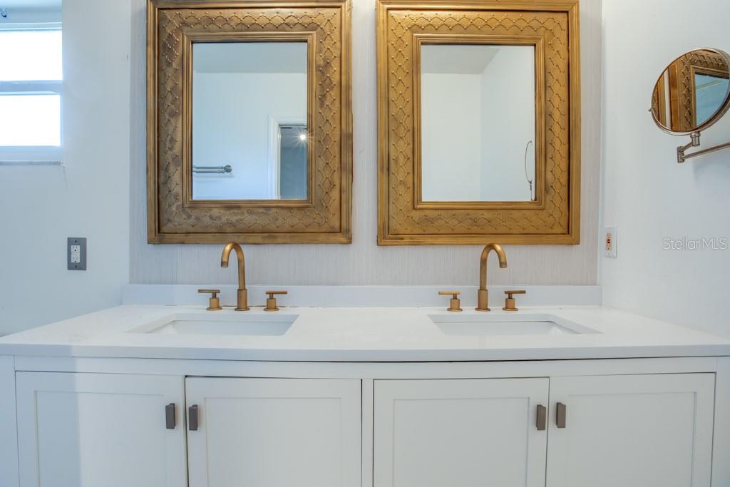 Primary bathroom boasts dual vanities.