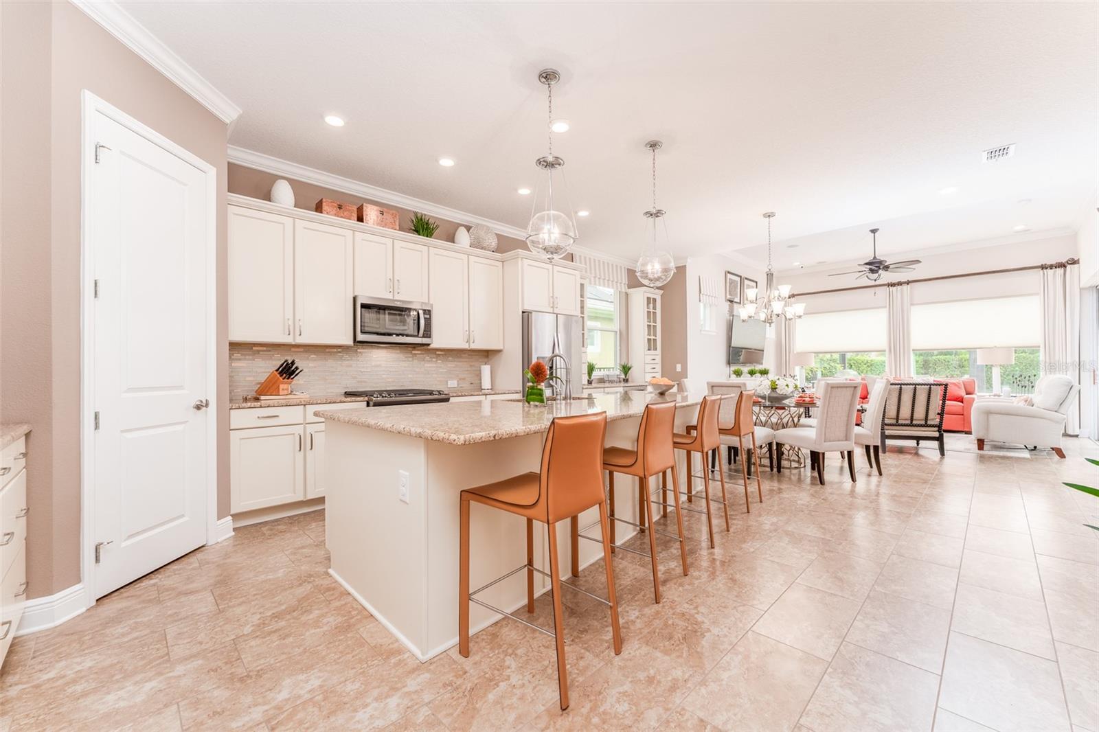 Well Equipped Kitchen with Elegant Backsplash, Pendant Lighting, Wood Soft Close Cabinets & Drawers & Stone Counters