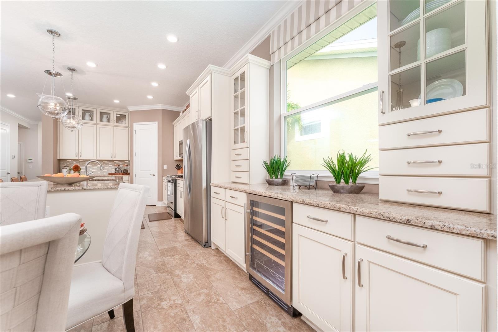 Dining Space with Additional Cabinetry & Serving Area & a Window For Natural Light
