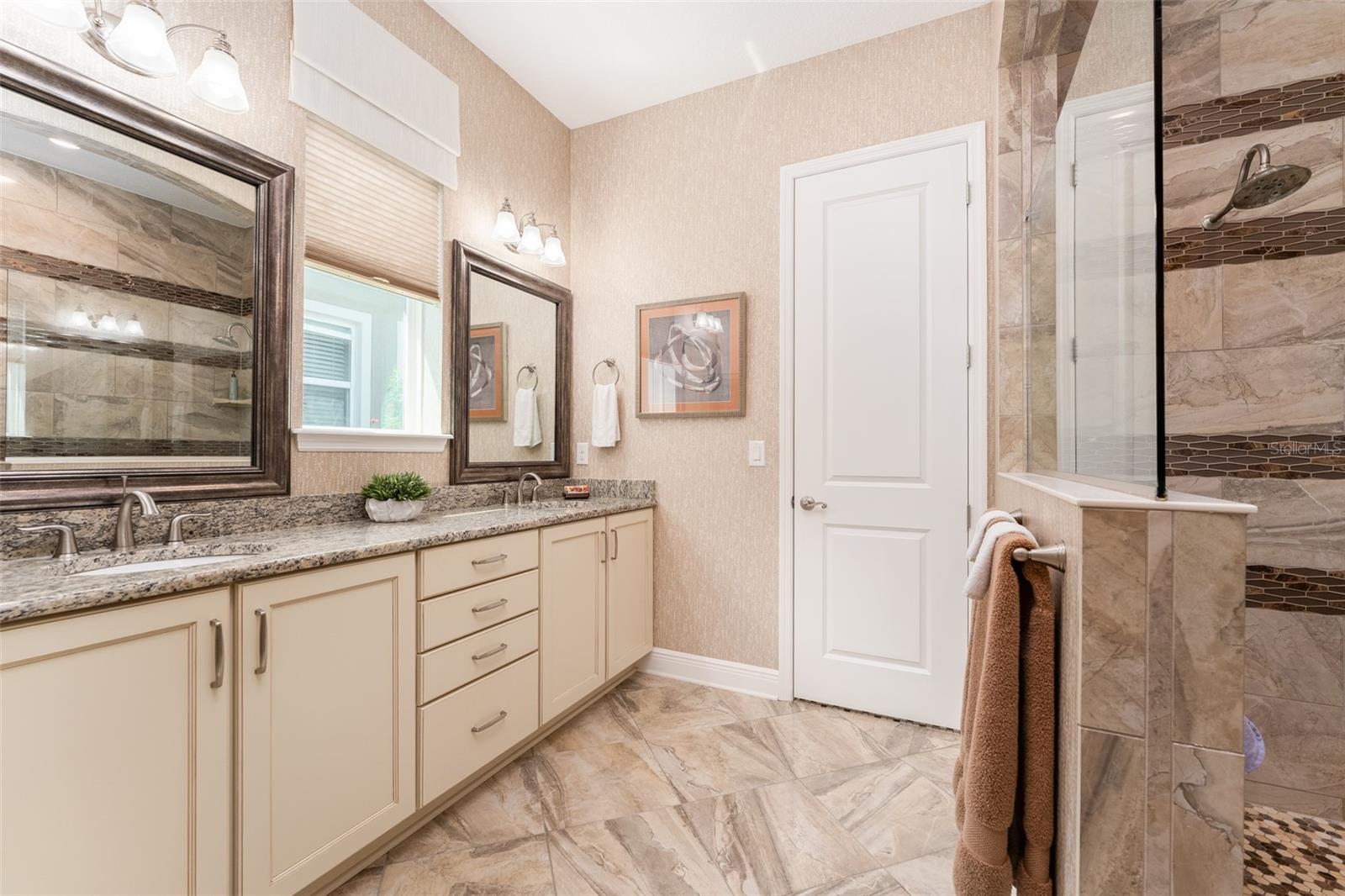 Delightful Primary Bath with Dual Vanities, Window for Natural Light, Stone Counter Tops & Walk in Shower