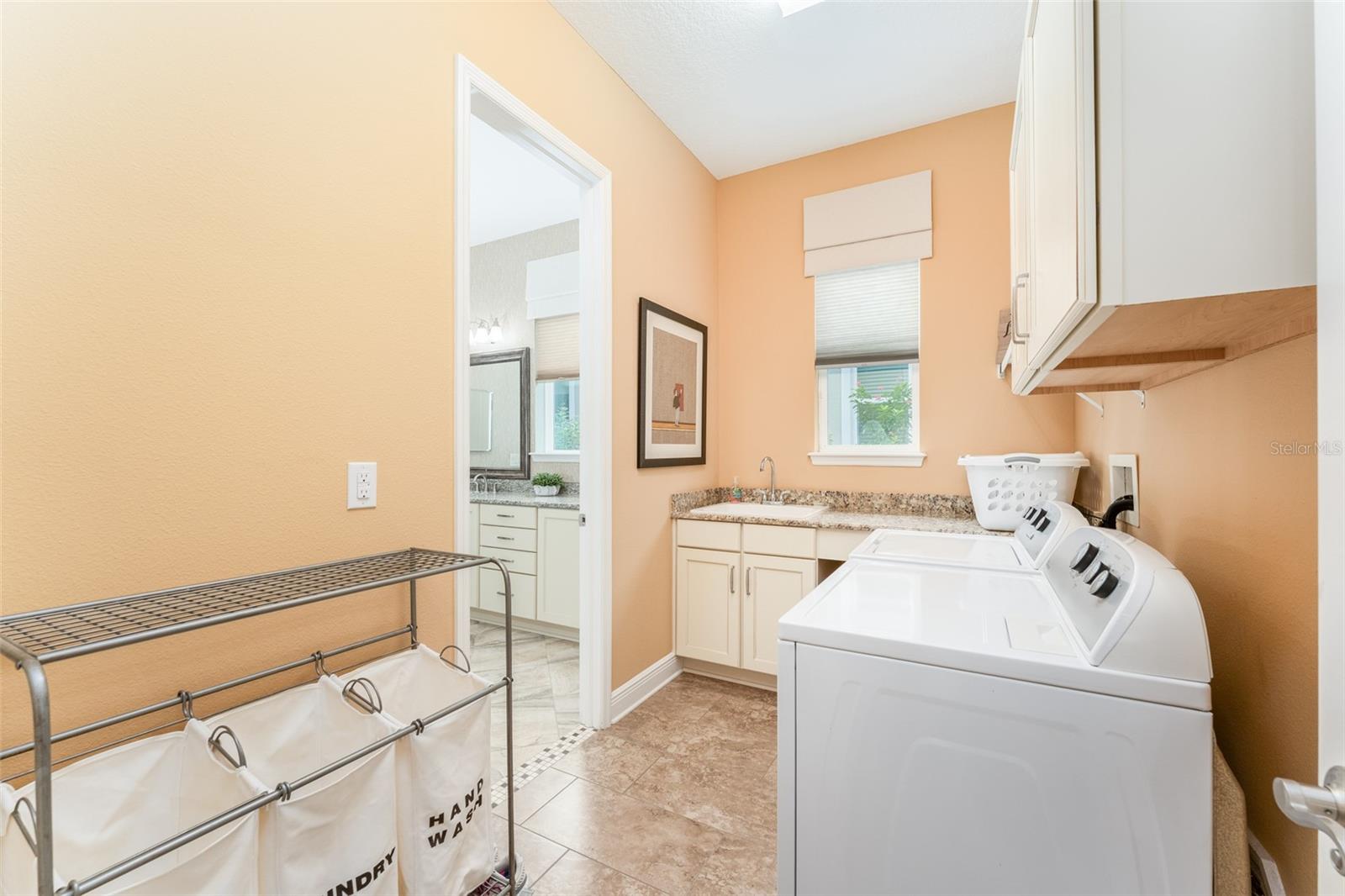 Laundry Room off Hallway with a door to Primary Suite