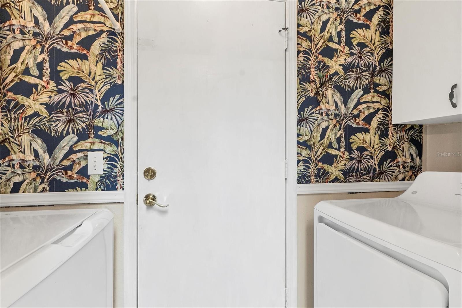 Laundry area with door to garage off kitchen