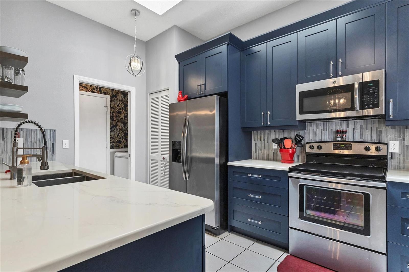 New kitchen with quartz countertops and tile