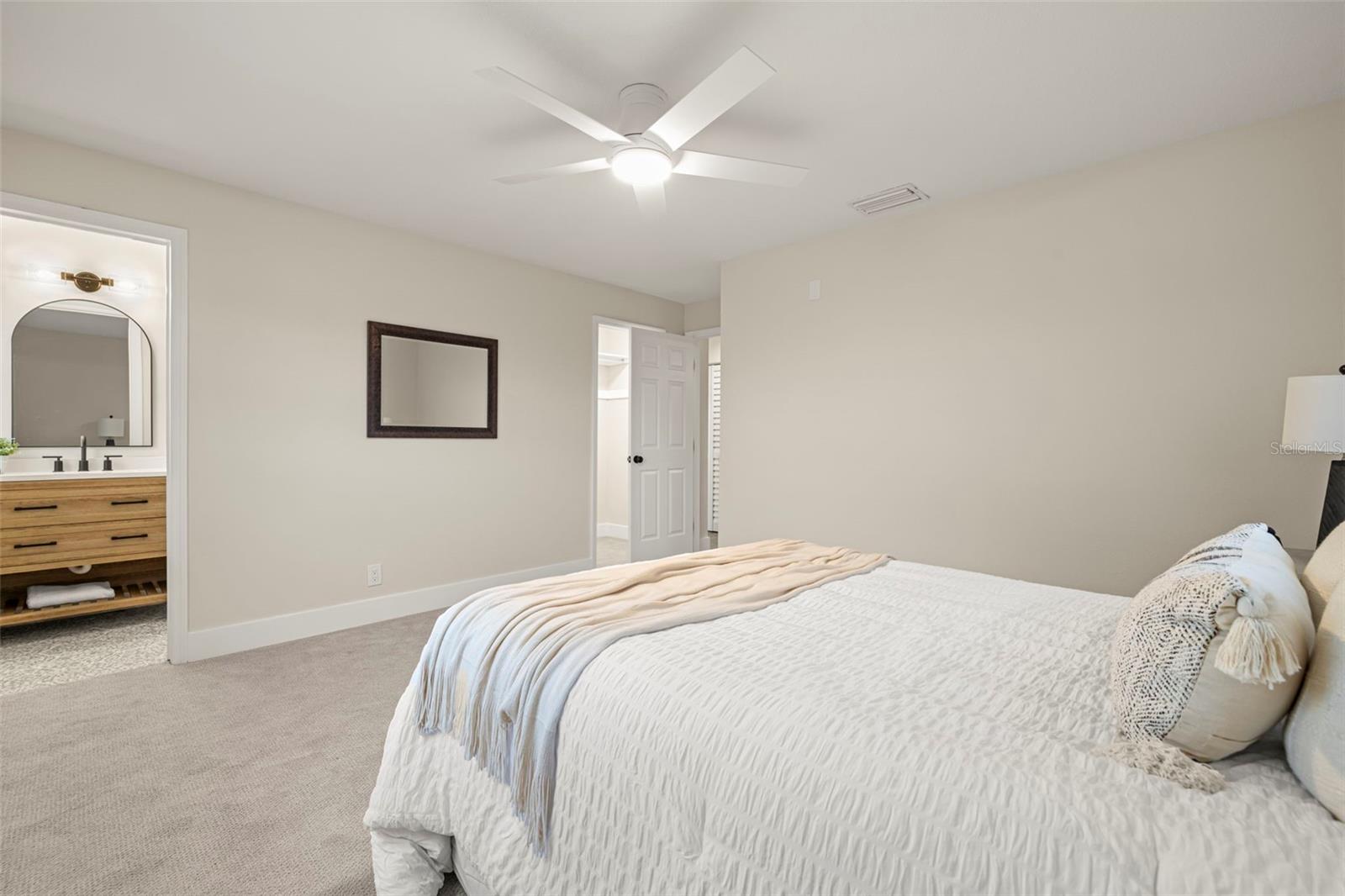 Primary bedroom with walk-in closet and en suite bathroom