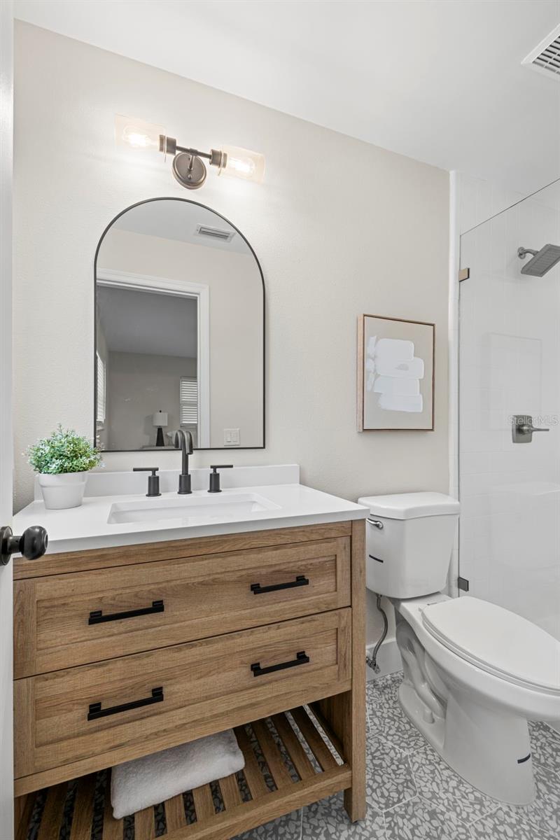 Primary ensuite with seamless glass shower stall