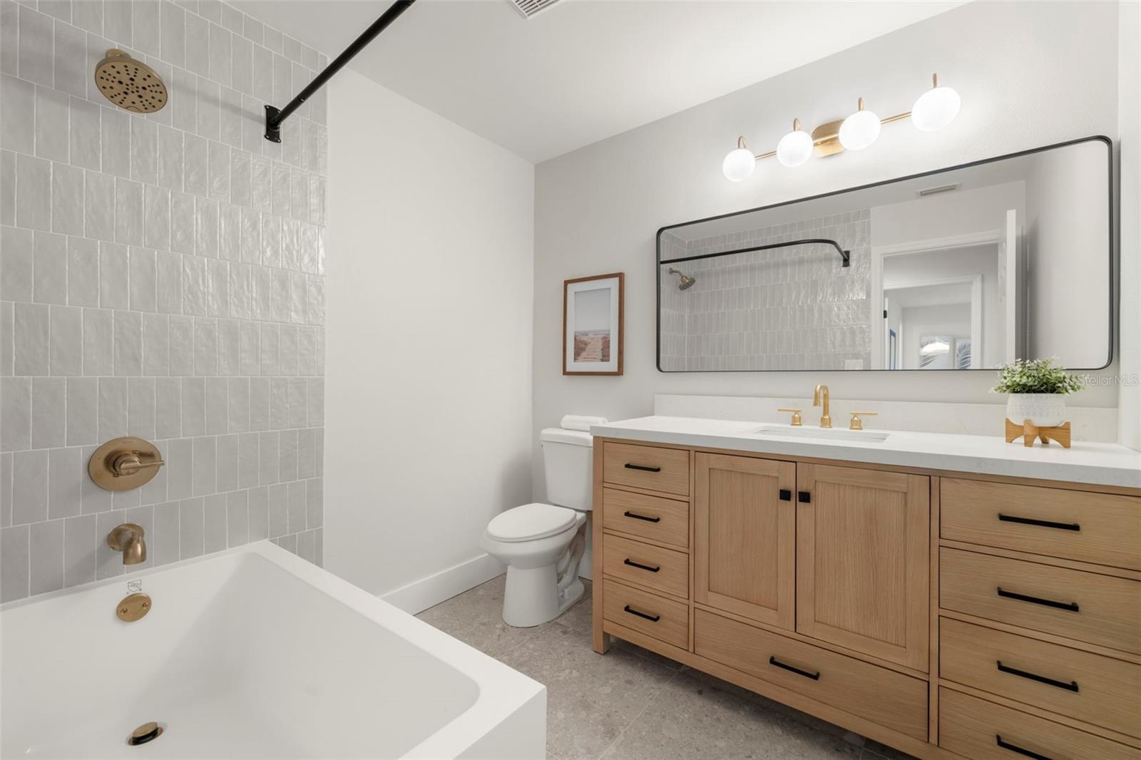 Hall bathroom with subway tile shower/tub combo