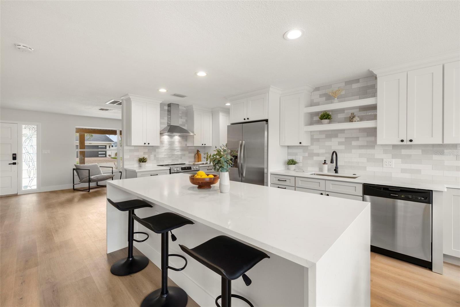 Center island with cascade waterfall Quartz counter tops