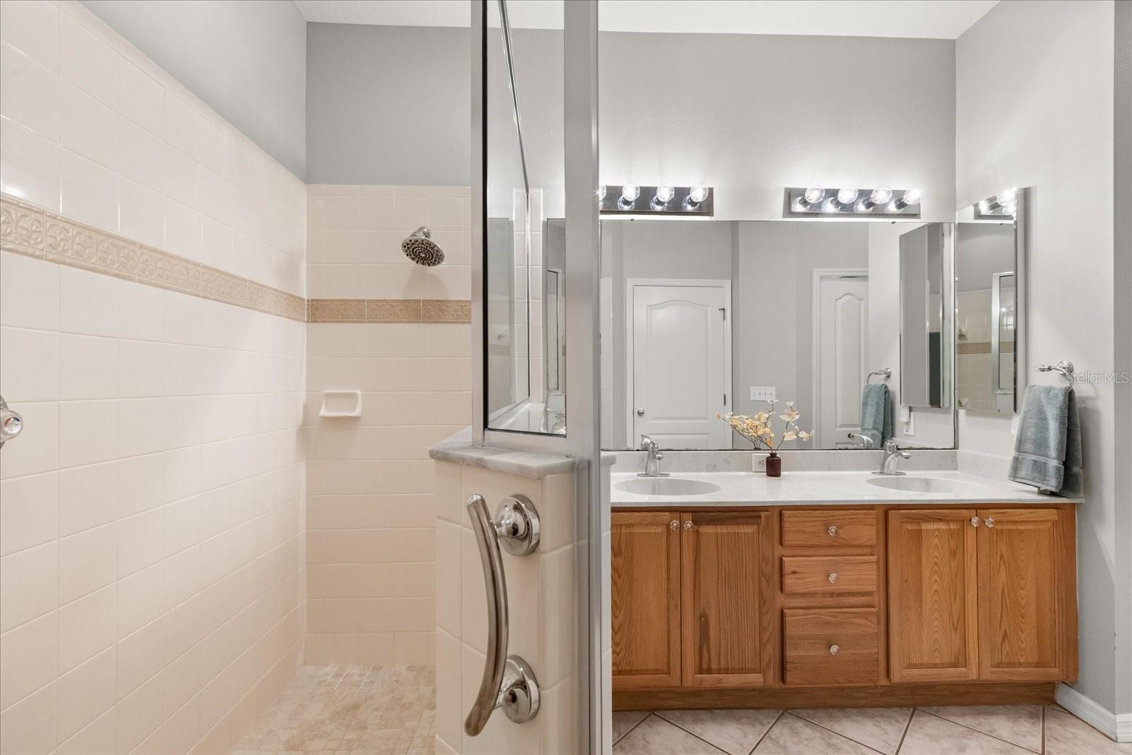 Walk-in shower, double vanity, water closet, his and hers walk-in closet