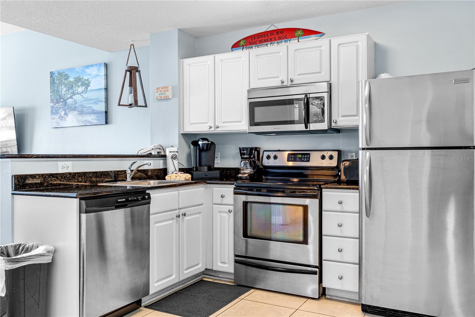 Fully equipped kitchen with stainless steel appliances and all the dishware needed.