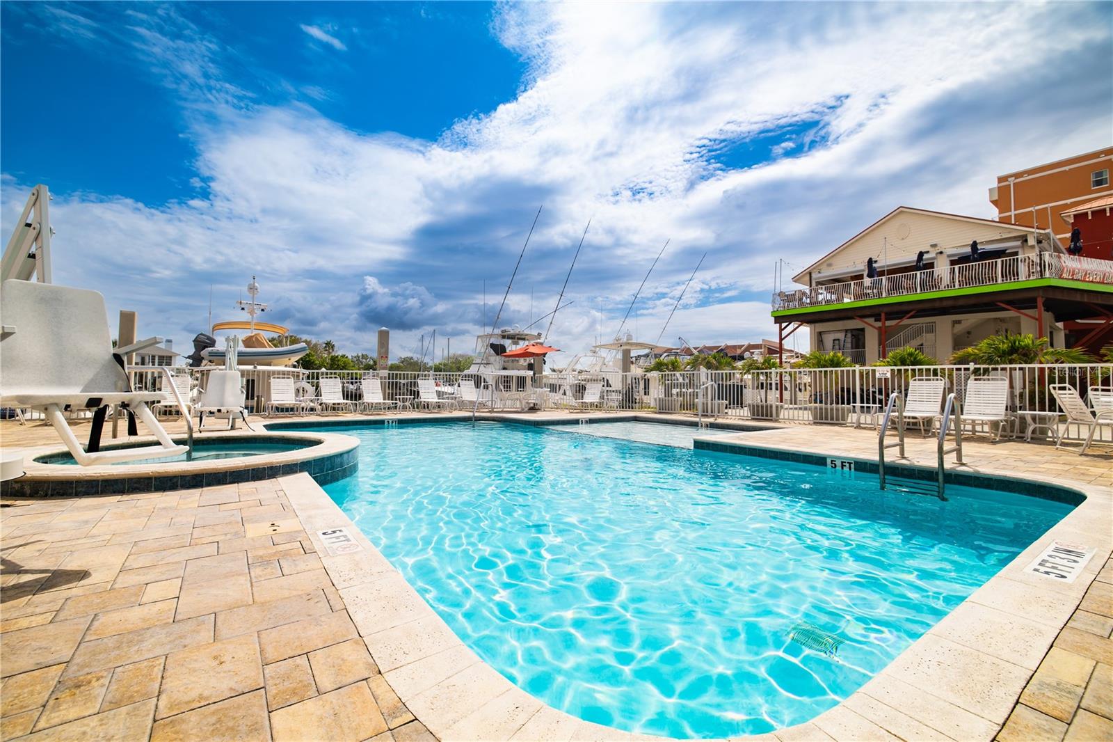 Sparkling waterfront pool and hot tub