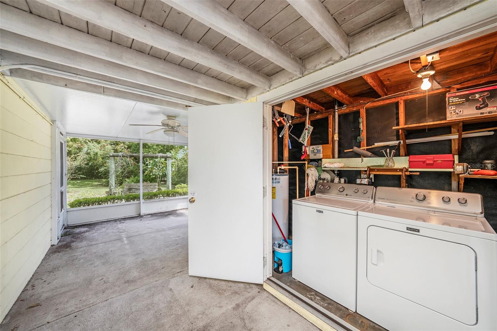 Screened and covered breezeway brings you to large utility closet!