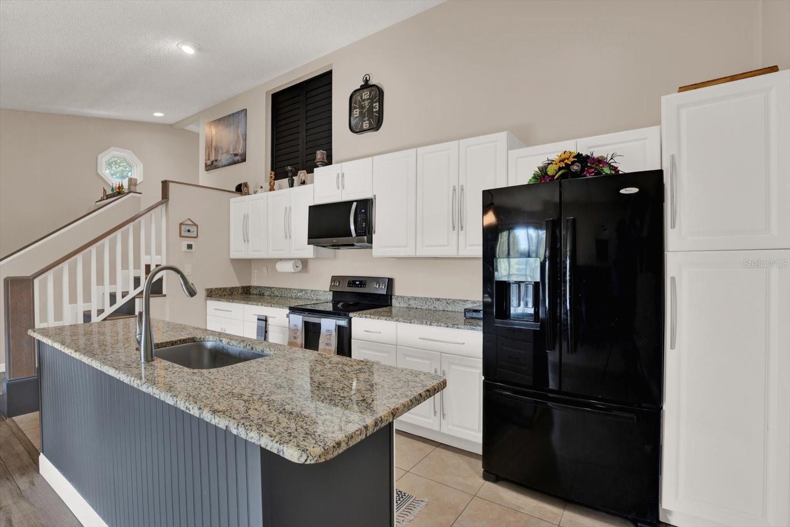 Open and Updated Kitchen with built-in pantry and granite countertops