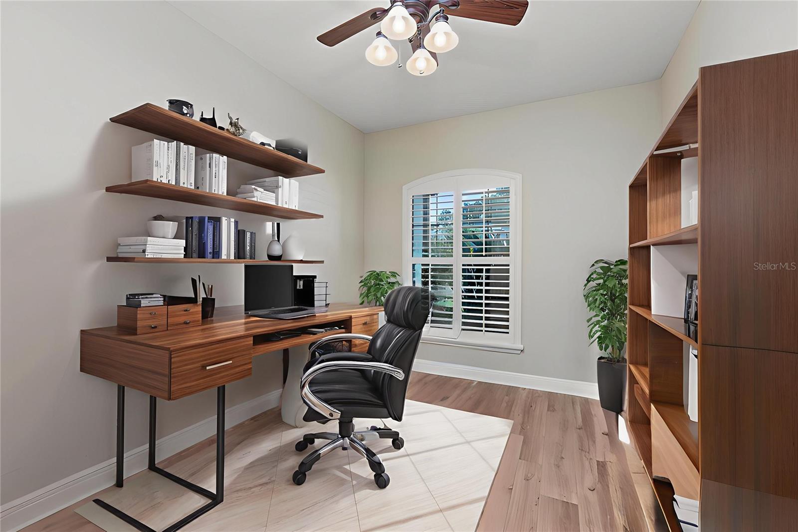 Office at the front of the home with doors for privacy