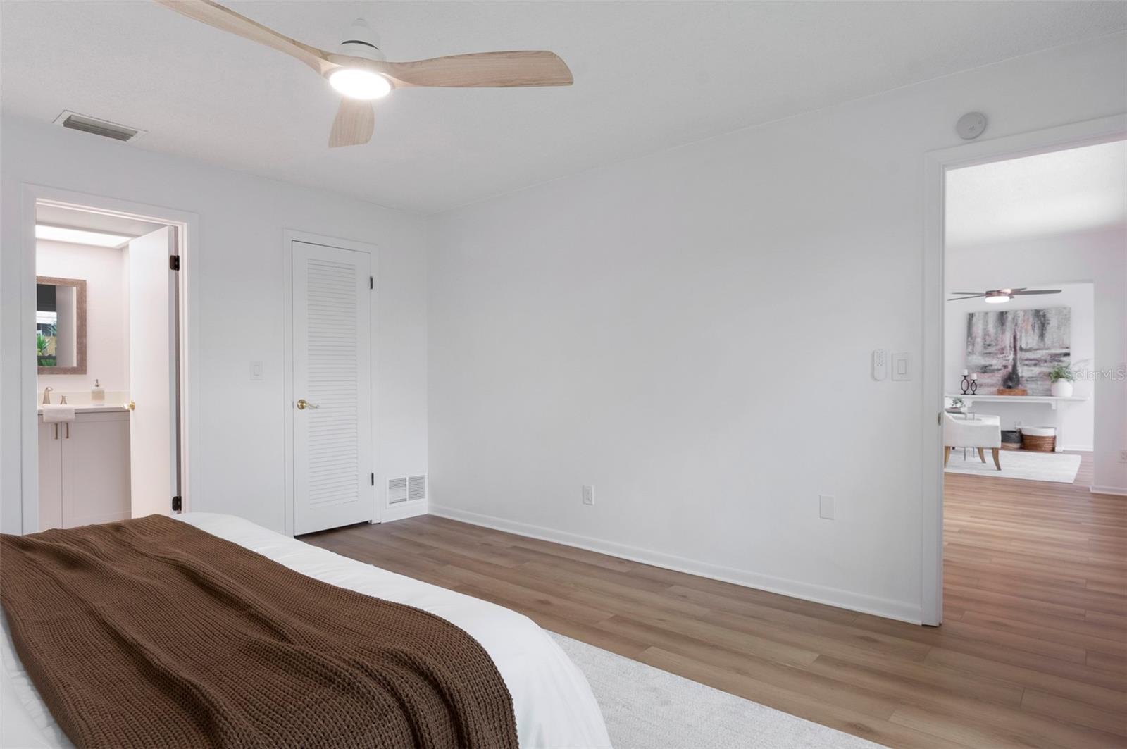 Primary bedroom with bathroom and a large walk-in closet.