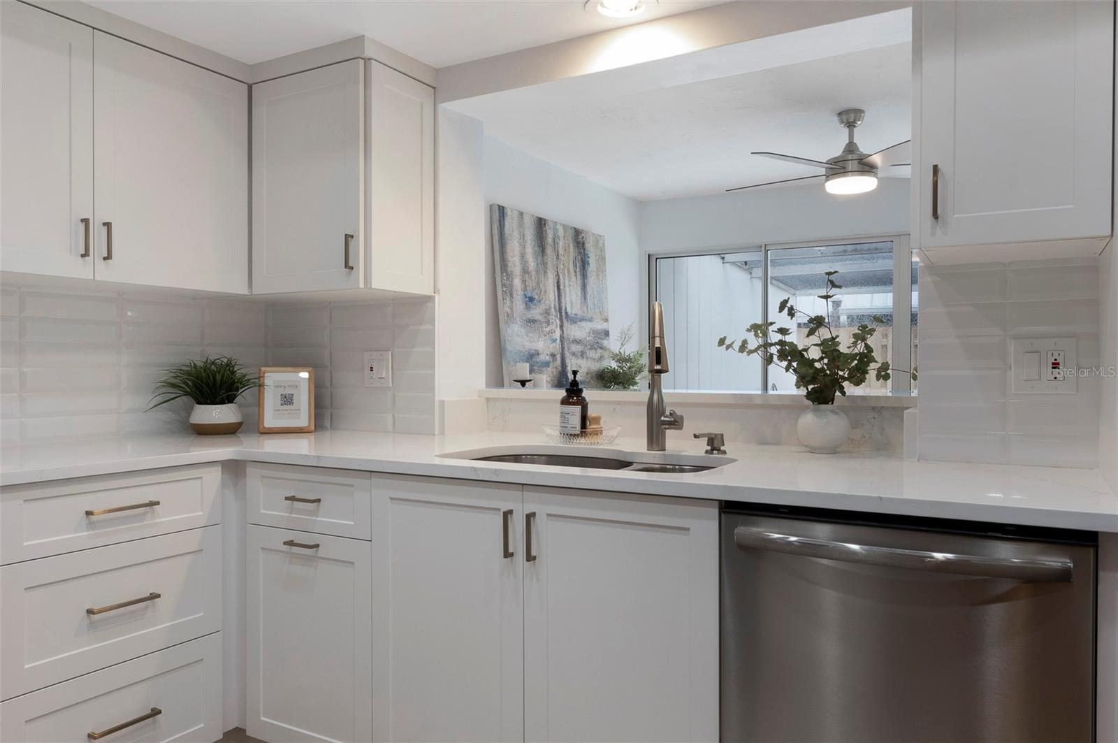 Kitchen! LOOK at the beautiful cabinetry! Fixtures and new appliances! Passthrough to the bonus area! Beyond a secluded screened patio!