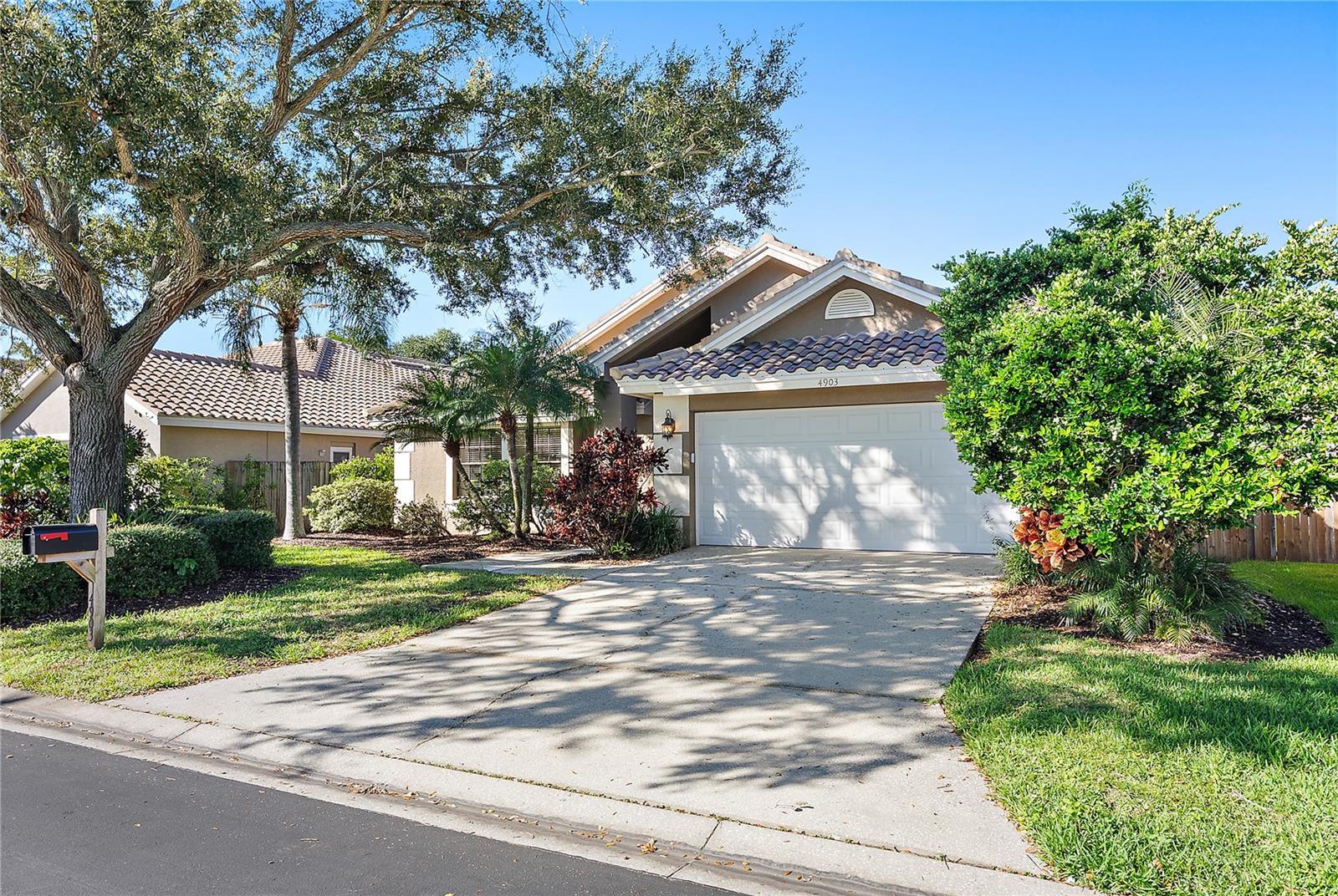 2 car garage with attic space, cabinets and shelving for storage
