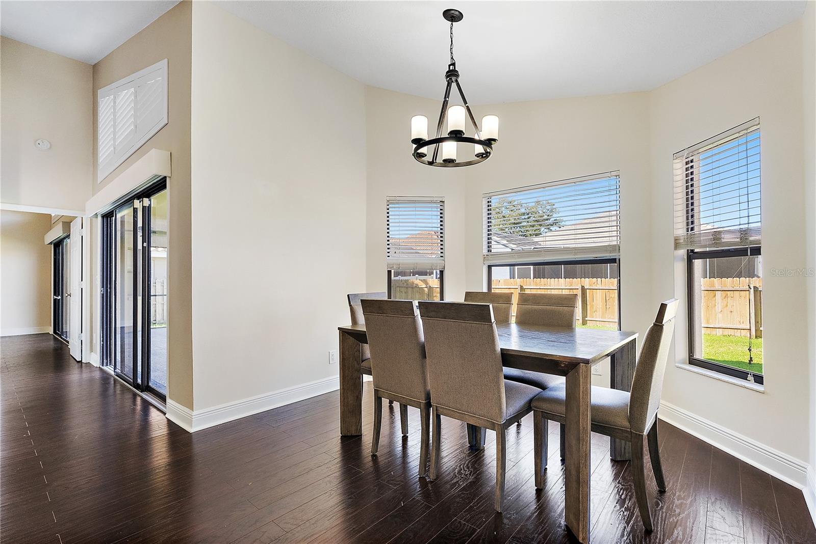 dining room with chandelier, bay window