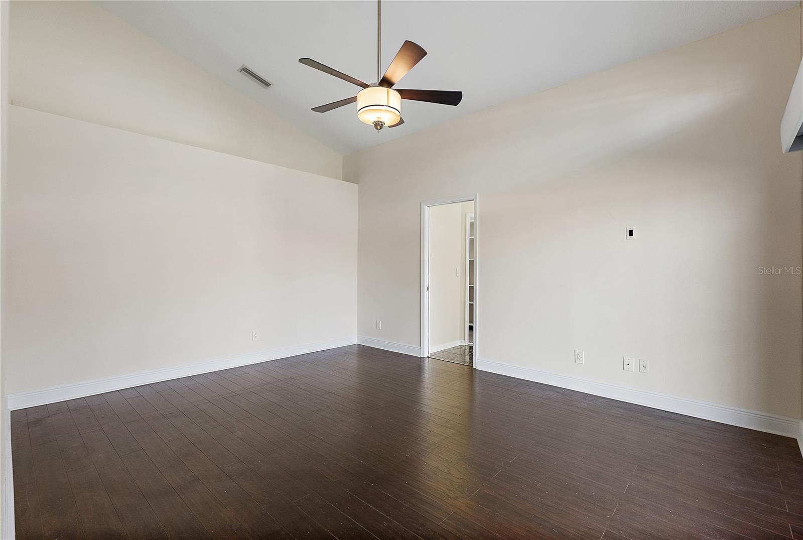 Large primary suite with high ceilings and fan