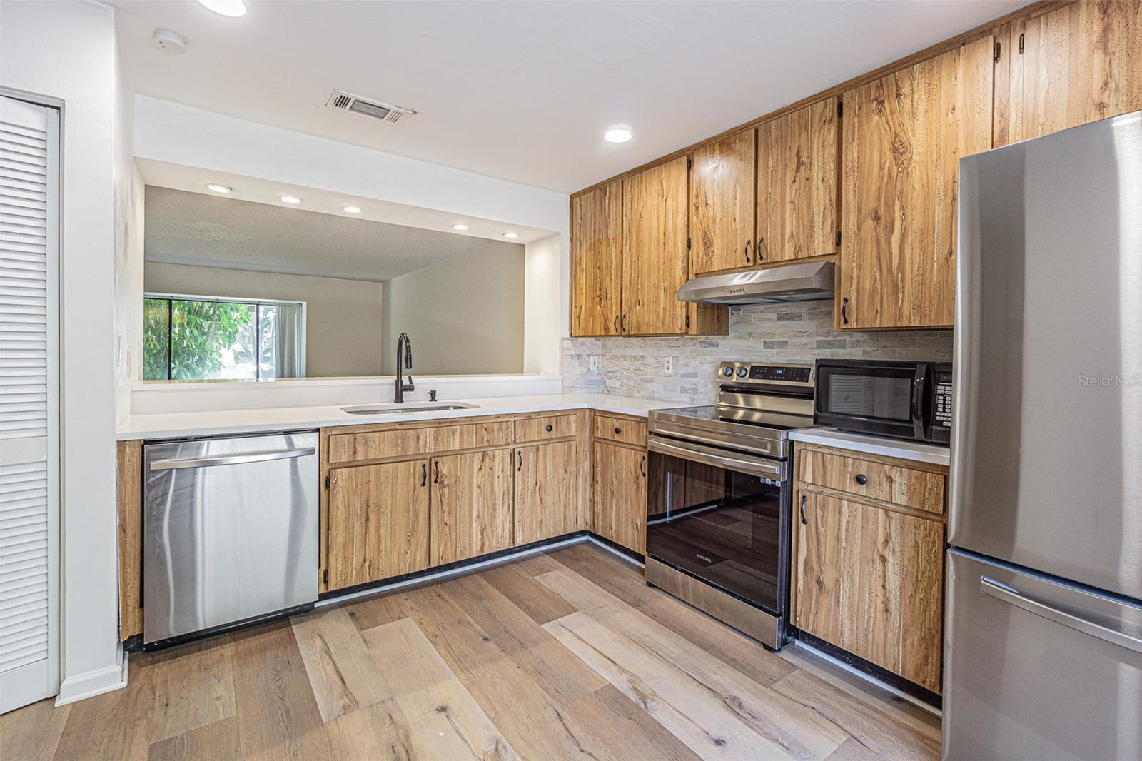 Kitchen with Stainless Steel appliances and Quartz counter tops.