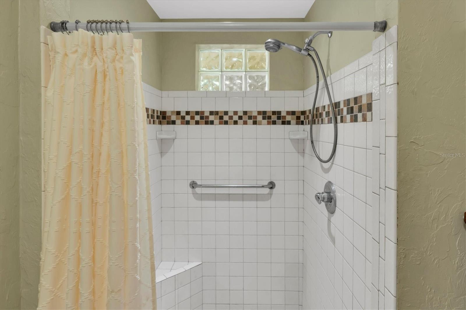 Primary Suite walk in shower - glass block window